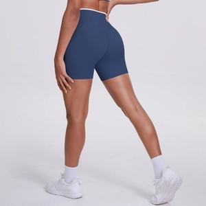 Close-up of high-waisted yoga shorts featuring contrast white waistband and navy fabric
