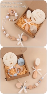 5-piece baby gift set with wooden brush, heart teether, and pacifier clip in a box