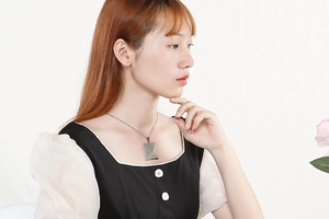 Polished silver geometric cube pendant necklace on a model showing daily wear style