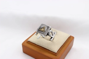 Detailed macro view of retro stainless steel ring with All-Seeing Eye and Ankh symbols