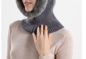 Close-up of grey ribbed knit balaclava featuring plush faux fur trim and warm ear protection