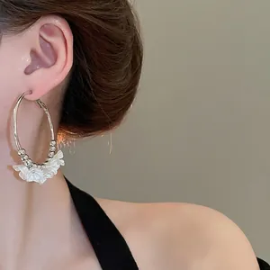 Elegant large silver hoop earrings featuring white acrylic flower petals and small beads