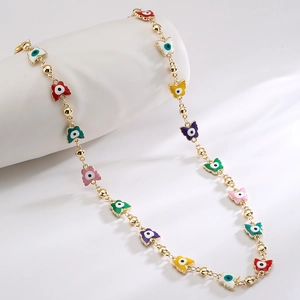 Gold chain necklace with colorful enamel butterfly pendants and evil eye motifs