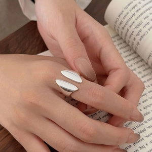 Elegant 925 sterling silver open ring with polished wing design on a lifestyle background