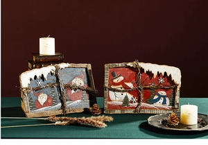 Detail of Santa and Snowman wooden festive ornaments with warm LED lighting and snow texture