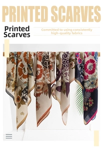 Collection of four printed silk scarves with floral patterns displayed on wooden hangers