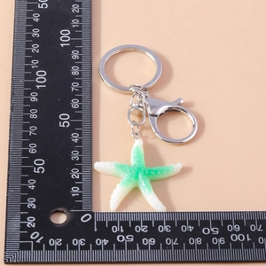 Detailed size view of green starfish keychain with measurement ruler in centimeters