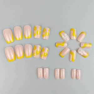 Floral press-on nail set featuring yellow flower patterns and 3D bow decorations