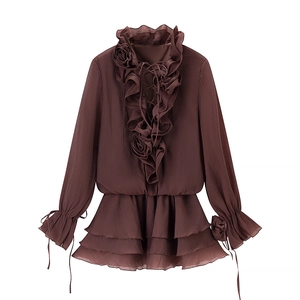 Detailed close-up of brown sheer chiffon dress featuring 3D floral lace and ruffled sleeves