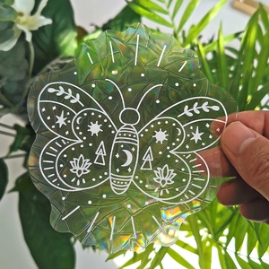 Rainbow suncatcher window film with holographic moth and moon prism patterns