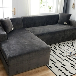 Detailed texture of thick dark grey velvet sofa cover and matching pillow on a couch