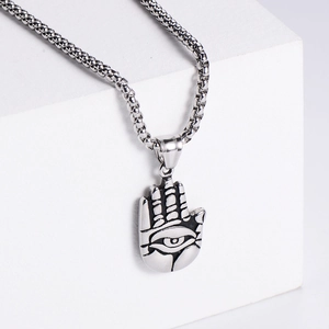 Close-up of vintage Hamsa Hand pendant with evil eye detail on a silver box chain