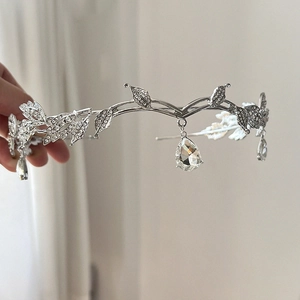 Detail of silver bridal leaf crown with sparkling rhinestones and crystal teardrop pendants