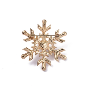 Detailed back view of golden snowflake brooch showing secure pin fastener mechanism