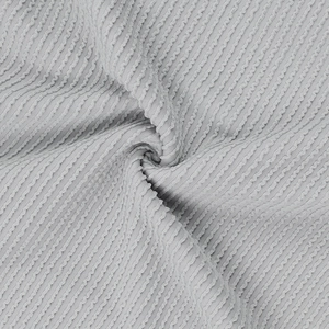 Macro shot of light grey waffle knit fabric texture showing high elasticity and soft knitwear