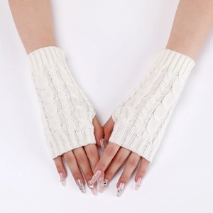Close-up of cream-white knitted fingerless gloves with a vintage cable knit pattern