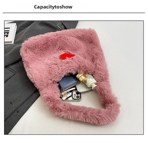 Capacity demonstration of the pink plush tote bag showing daily items on white background