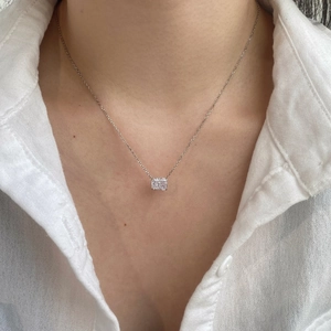 Close-up of S925 sterling silver necklace with emerald cut pendant on a model