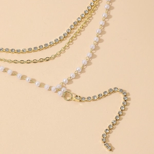 Elegant multi-layer gold necklace with pearls, rhinestones and tassel fringe detail