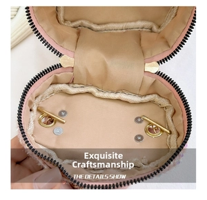 Close-up of pink tweed mini bag interior with gold zipper and beige lining detail