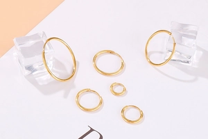 Polished gold 304 stainless steel hoop earrings in various sizes with glossy finish