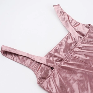 Detailed close-up of wide straps and smooth stitching on a pink satin formal dress
