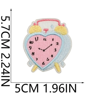 Detail view of heart-shaped alarm clock embroidery patch with 5.7cm x 5cm size scale