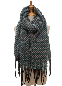 Detailed view of knitted scarf with multicolored chevron pattern and black fringe trim