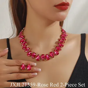 Close-up of a model wearing rose red teardrop crystal necklace and earring set