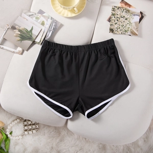 Detailed flat lay of black athletic shorts with white trim and elastic waistband