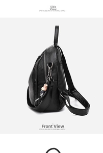 Side view of black faux leather backpack with litchi texture and cute doll charm