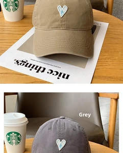 Detail of heart embroidery on cotton baseball caps in khaki and grey colors