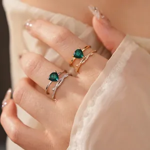Luxury gold plated crisscross ring set with green triangular zircon stones for women