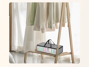 Gray foldable fabric organizer bag with clear window placed on a wooden closet shelf