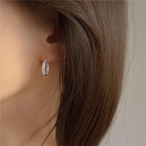 Close-up of sparkling S925 sterling silver hoop earrings with pave cubic zirconia