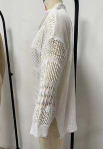 Detalle de la bata de punto calado blanco con textura de malla y abertura lateral