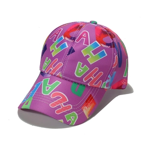 Purple baseball cap with colorful letter prints and curved brim in 45-degree angle view