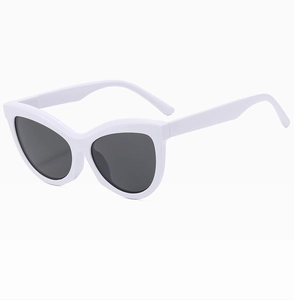 Detail shot of white cat-eye sunglasses with dark lenses and lightweight frames