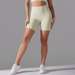Detail of high-waisted seamless fitness shorts in cream yellow with smooth elastic fabric