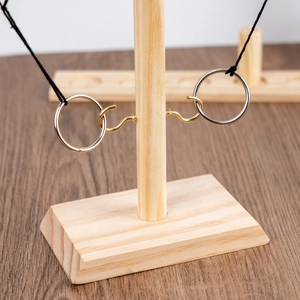Classic wooden hook and ring toss battle game with golden hooks for tabletop play