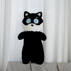 Detail shot of a cartoon plush dog toy skin with big blue eyes on grey fabric