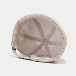 Detail view of cotton docker hat lining with reinforcement tape and adjustable metal buckle