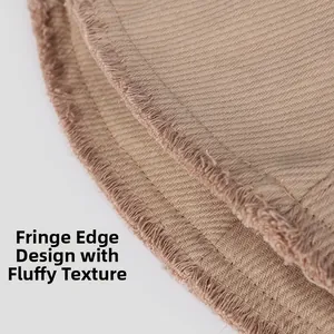 Macro shot of khaki bucket hat featuring frayed brim detail and raw edge twill fabric texture