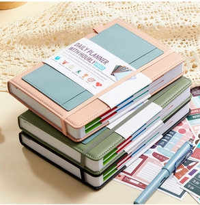 Detail view of colorful undated daily planners with elastic straps and functional stickers
