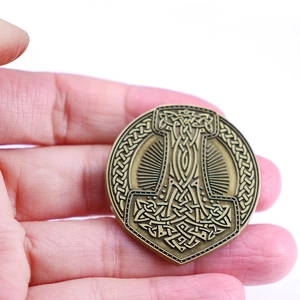Bronze Viking Mjolnir rune brooch with Celtic knot held in hand for scale and detail