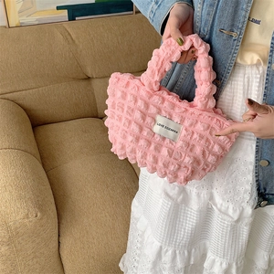 Close-up of pink popcorn textured handbag with LOVE SOZAKKA label and casual style