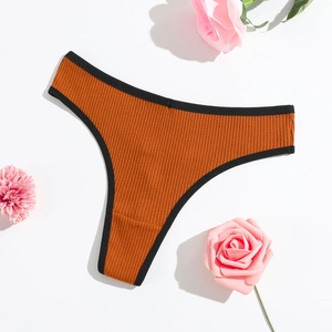 Rust orange ribbed cotton thong with black contrast trim on white background
