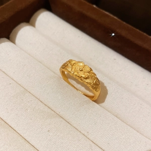 Detailed macro view of retro 24k gold flower ring with matte sandblasted petal texture