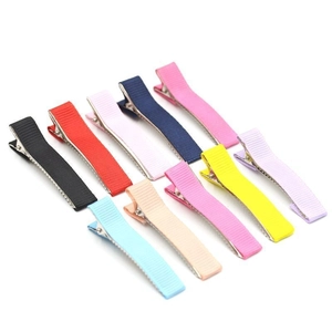 Close-up of colorful striped ribbon duckbill hair clips in nine different candy colors