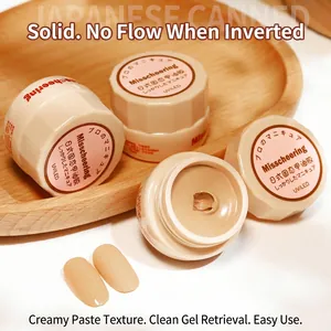 Nude solid cream gel polish in small round pots on a minimalist wooden tray